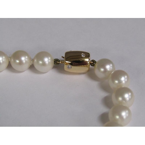 101 - A cultured pearl and diamond necklace with twenty four akoya cultured pearls, 18ct gold clasps set w... 