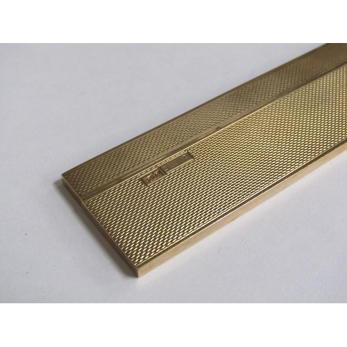 105 - A 9ct gold engine turned cased comb, makers marks S J R, Birmingham 1977, 36.6g total.