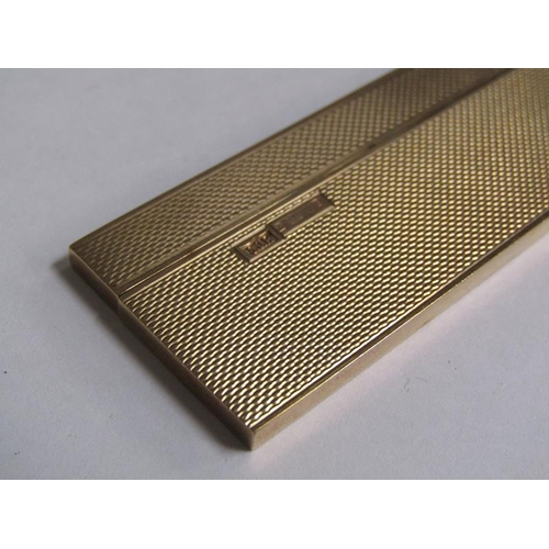 105 - A 9ct gold engine turned cased comb, makers marks S J R, Birmingham 1977, 36.6g total.