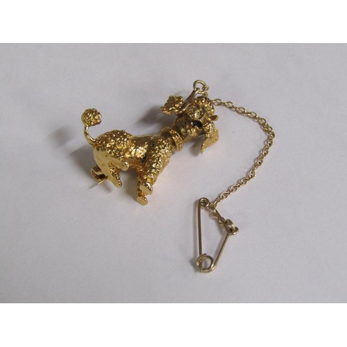 109 - A 9ct gold poodle brooch with ruby eyes and a safety chain, 5.6g.