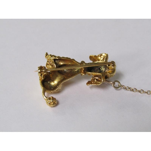 109 - A 9ct gold poodle brooch with ruby eyes and a safety chain, 5.6g.