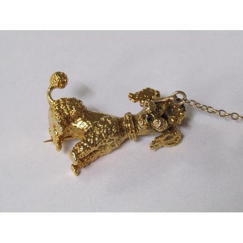 109 - A 9ct gold poodle brooch with ruby eyes and a safety chain, 5.6g.