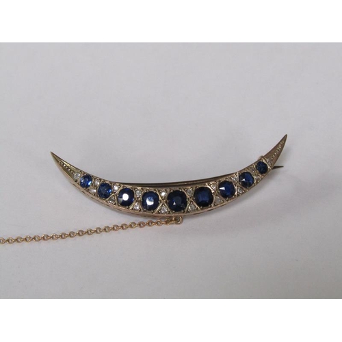 114 - A gold sapphire and diamond set crescent brooch, 5.25cm l.