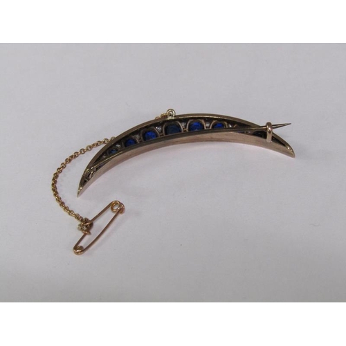 114 - A gold sapphire and diamond set crescent brooch, 5.25cm l.