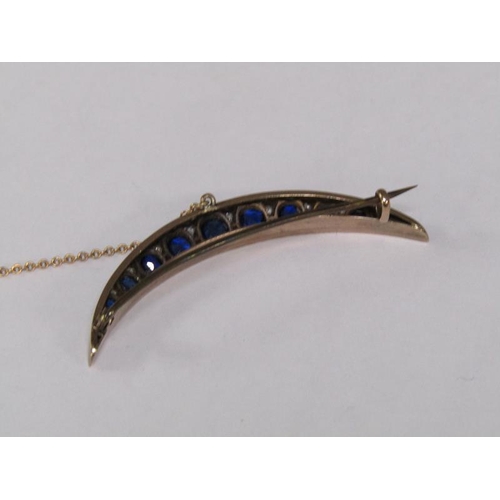114 - A gold sapphire and diamond set crescent brooch, 5.25cm l.