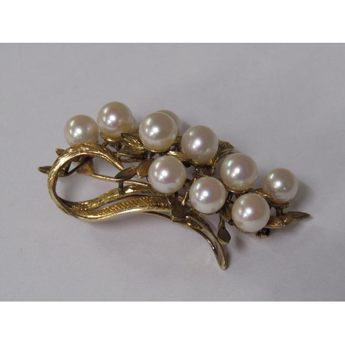 115 - A 14ct gold scrolling floral brooch, pearl set.