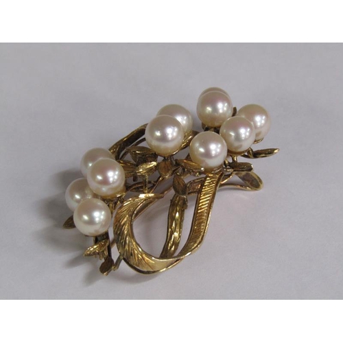 115 - A 14ct gold scrolling floral brooch, pearl set.