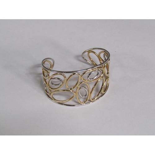 119 - A 9ct two colour gold open bracelet, 11.8g.
