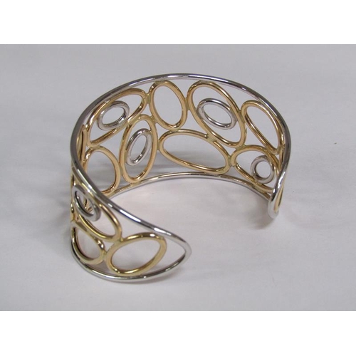 119 - A 9ct two colour gold open bracelet, 11.8g.