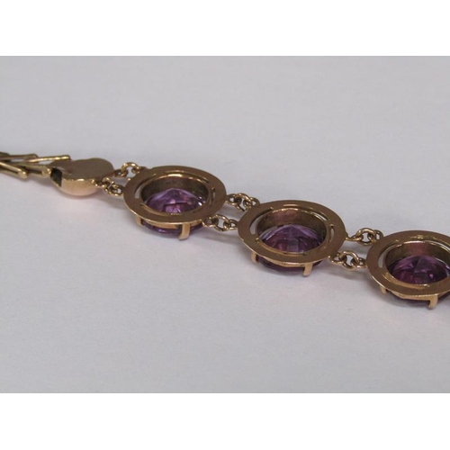 120 - An Egyptian gold bracelet set with four cut amethysts, total 18.4g, 18.5cm l.