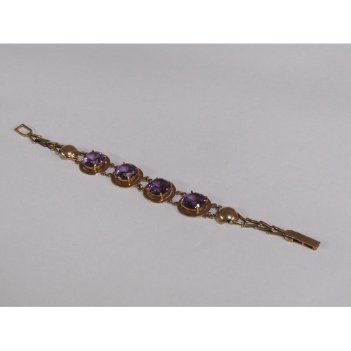 120 - An Egyptian gold bracelet set with four cut amethysts, total 18.4g, 18.5cm l.