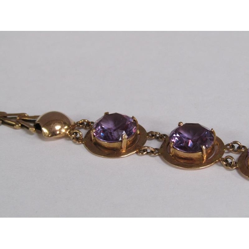 120 - An Egyptian gold bracelet set with four cut amethysts, total 18.4g, 18.5cm l.