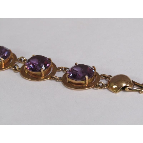 120 - An Egyptian gold bracelet set with four cut amethysts, total 18.4g, 18.5cm l.