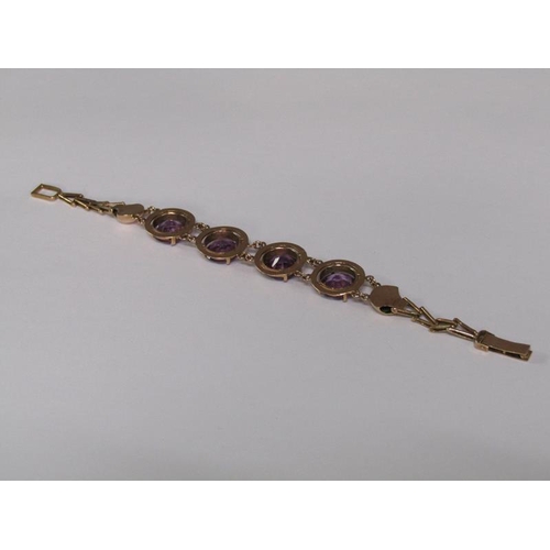 120 - An Egyptian gold bracelet set with four cut amethysts, total 18.4g, 18.5cm l.