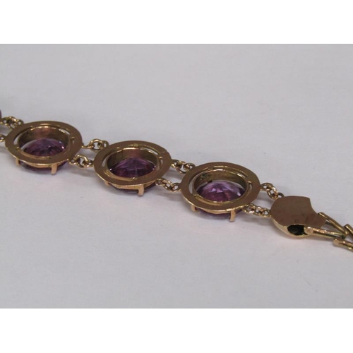 120 - An Egyptian gold bracelet set with four cut amethysts, total 18.4g, 18.5cm l.