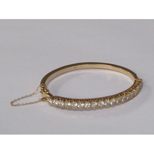 123 - A gold bracelet set with a continuous band of twenty brilliant cut diamonds, total 20g.