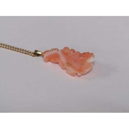 124 - A 14ct gold ring set with rose carved coral setting, size M 1/2, together with a 14ct gold chain wit... 