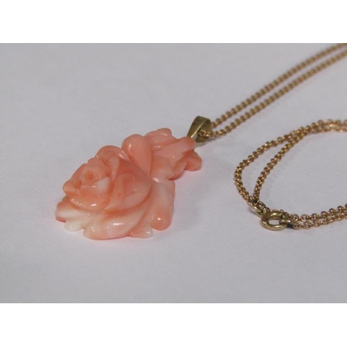 124 - A 14ct gold ring set with rose carved coral setting, size M 1/2, together with a 14ct gold chain wit... 