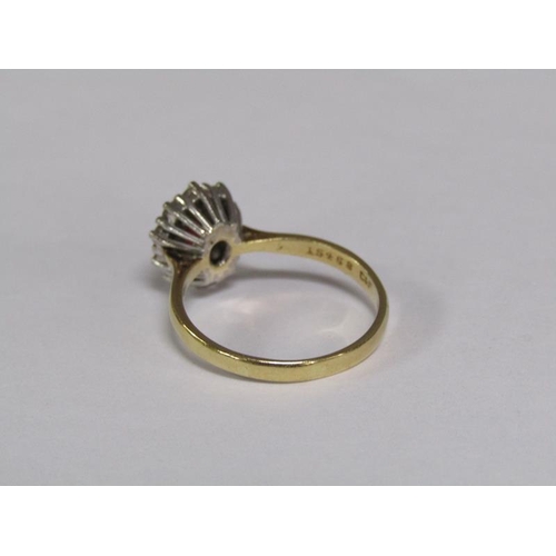 131 - An 18ct gold ruby and diamond set ring, size R.