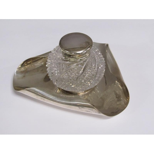 170 - An Art Deco silver single bottle inkstand, the globular cut glass bottle with silver mount and hinge... 