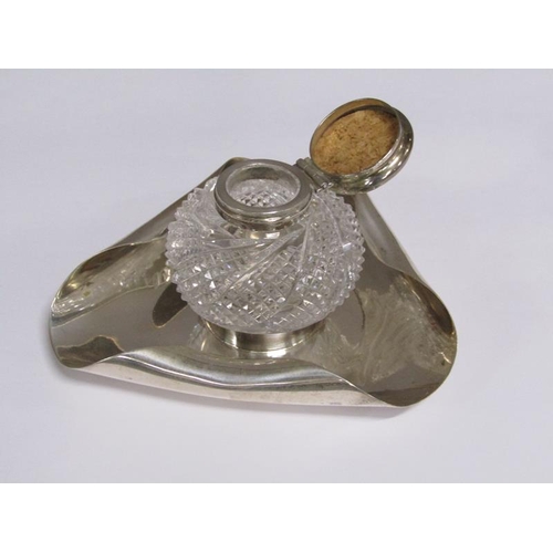 170 - An Art Deco silver single bottle inkstand, the globular cut glass bottle with silver mount and hinge... 