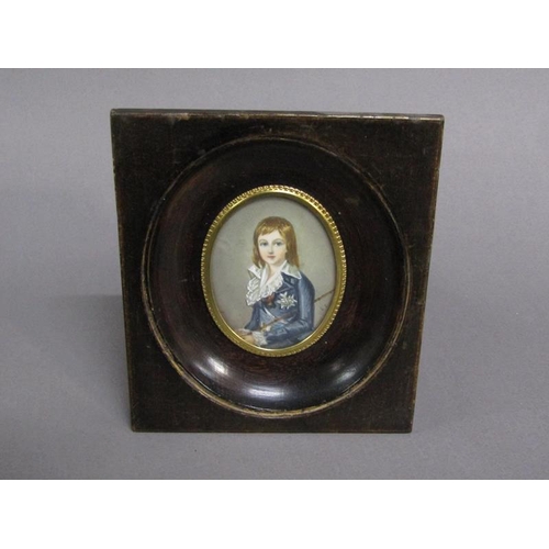 83 - Portrait of a young boy in early 19c costume holding a cane, signed in mono, oval framed and glazed,... 
