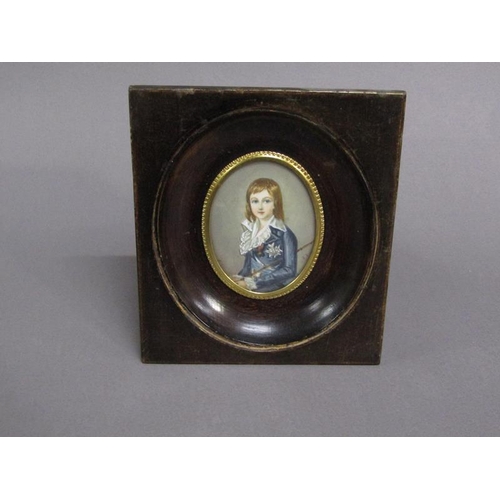 83 - Portrait of a young boy in early 19c costume holding a cane, signed in mono, oval framed and glazed,... 