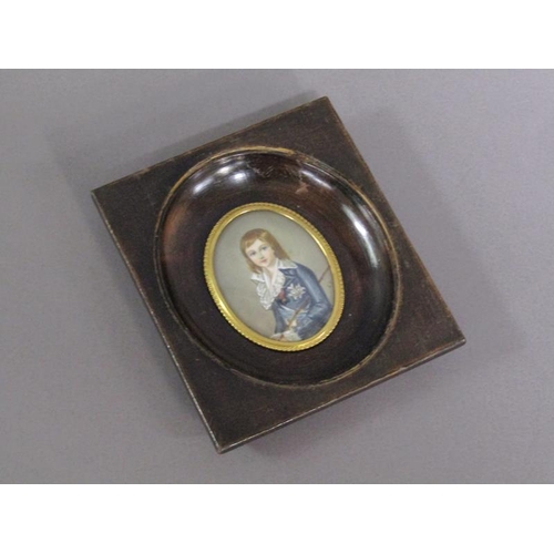 83 - Portrait of a young boy in early 19c costume holding a cane, signed in mono, oval framed and glazed,... 