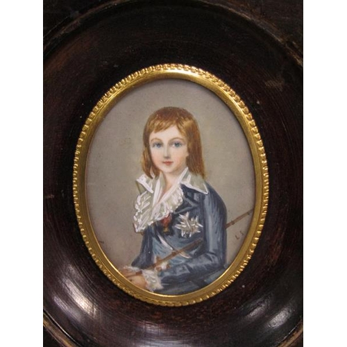 83 - Portrait of a young boy in early 19c costume holding a cane, signed in mono, oval framed and glazed,... 