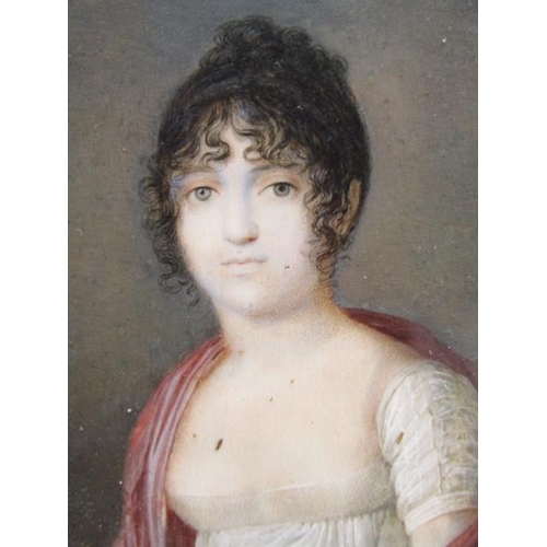85 - Unsigned - A mid 19c portrait of a lady, circular framed and glazed, 7cm diam.