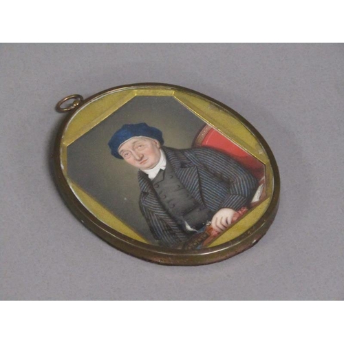 87 - A 19c framed oval portrait miniature of a gentleman seated at a table, framed and glazed, 9cm x 7cm.