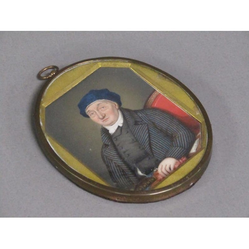 87 - A 19c framed oval portrait miniature of a gentleman seated at a table, framed and glazed, 9cm x 7cm.