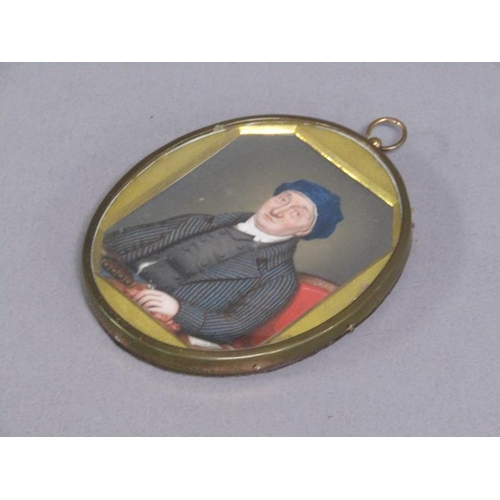 87 - A 19c framed oval portrait miniature of a gentleman seated at a table, framed and glazed, 9cm x 7cm.