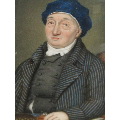 87 - A 19c framed oval portrait miniature of a gentleman seated at a table, framed and glazed, 9cm x 7cm.