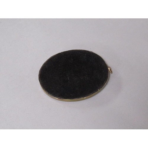 87 - A 19c framed oval portrait miniature of a gentleman seated at a table, framed and glazed, 9cm x 7cm.