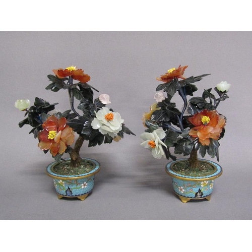 81 - A pair of Oriental stone and cloisonne peony trees, the leaves carved with Chinese jade, rose quartz... 
