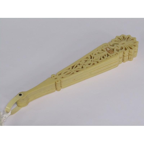 67 - A Victorian ivory fan with silk ribbon with pierced sticks, 39cm w.