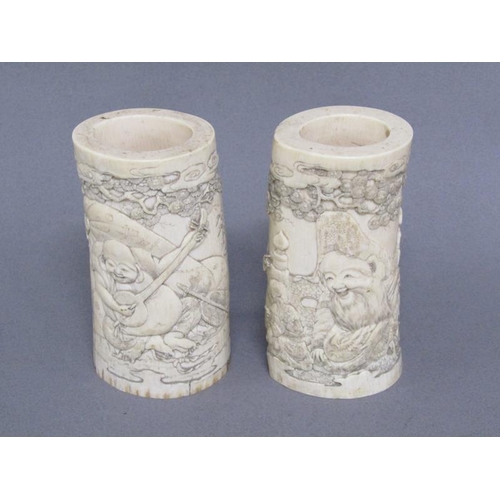 73 - A pair of Japanese ivory vases carved with a scene of Shoulao seated and with children and attendant... 
