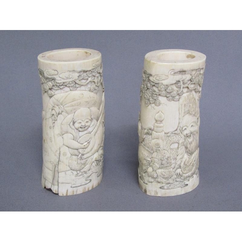 73 - A pair of Japanese ivory vases carved with a scene of Shoulao seated and with children and attendant... 