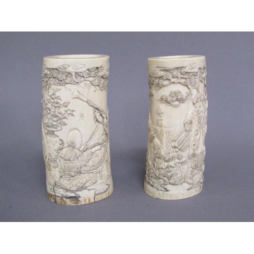73 - A pair of Japanese ivory vases carved with a scene of Shoulao seated and with children and attendant... 