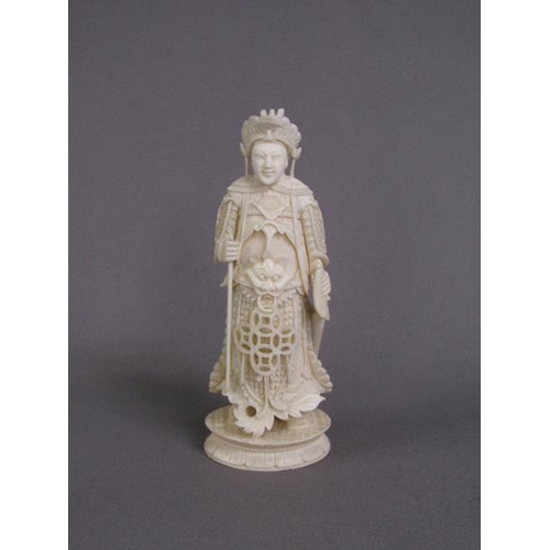 74 - Two Cantonese carved ivory chess pieces, one white, the other stained red, 13cm & 15cm h.