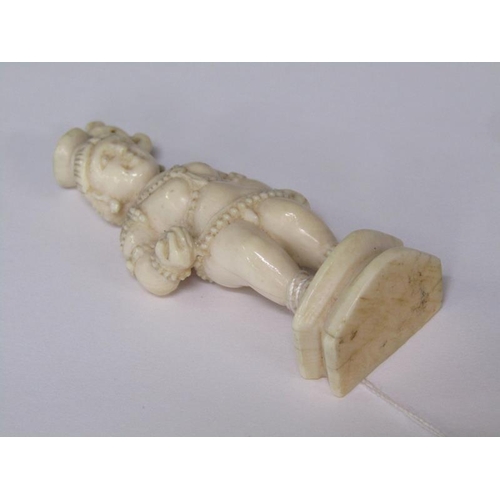 75 - A 19c Indian ivory carving depicting Lord Krishna, 6cm h.