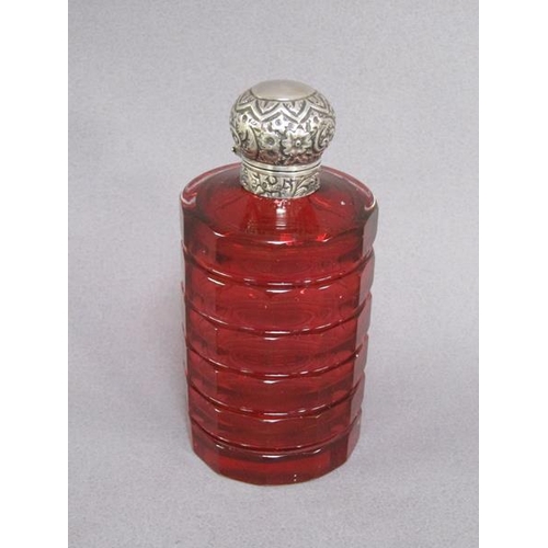 79 - A late Victorian ruby glass scent bottle, facet cut and with an embossed silver hinged dome top and ... 