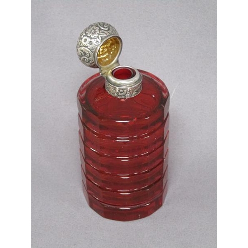 79 - A late Victorian ruby glass scent bottle, facet cut and with an embossed silver hinged dome top and ... 
