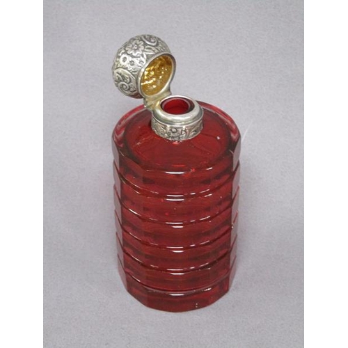 79 - A late Victorian ruby glass scent bottle, facet cut and with an embossed silver hinged dome top and ... 