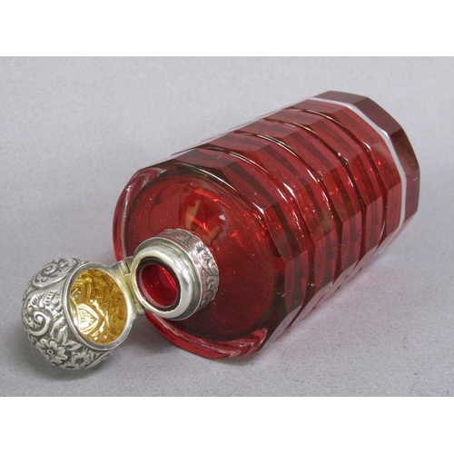 79 - A late Victorian ruby glass scent bottle, facet cut and with an embossed silver hinged dome top and ... 