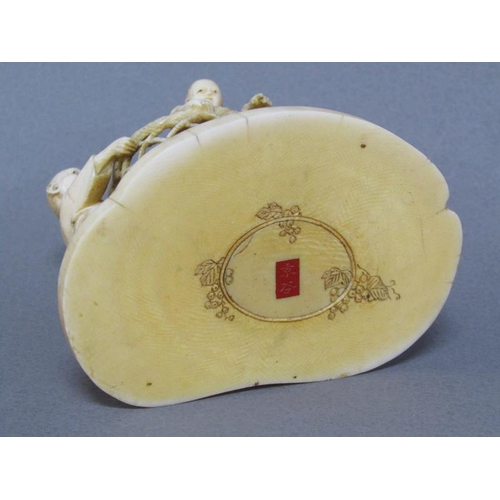 82 - A Japanese Meiji period ivory figure group of a lady and gentleman holding aloft a basket containing... 