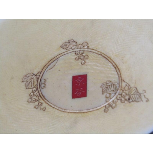 82 - A Japanese Meiji period ivory figure group of a lady and gentleman holding aloft a basket containing... 