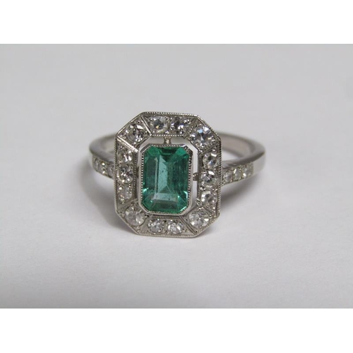 140 - A platinum emerald (0.9ct) and diamond (total 0.5ct) cluster ring, size N/O.