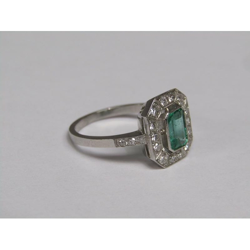 140 - A platinum emerald (0.9ct) and diamond (total 0.5ct) cluster ring, size N/O.